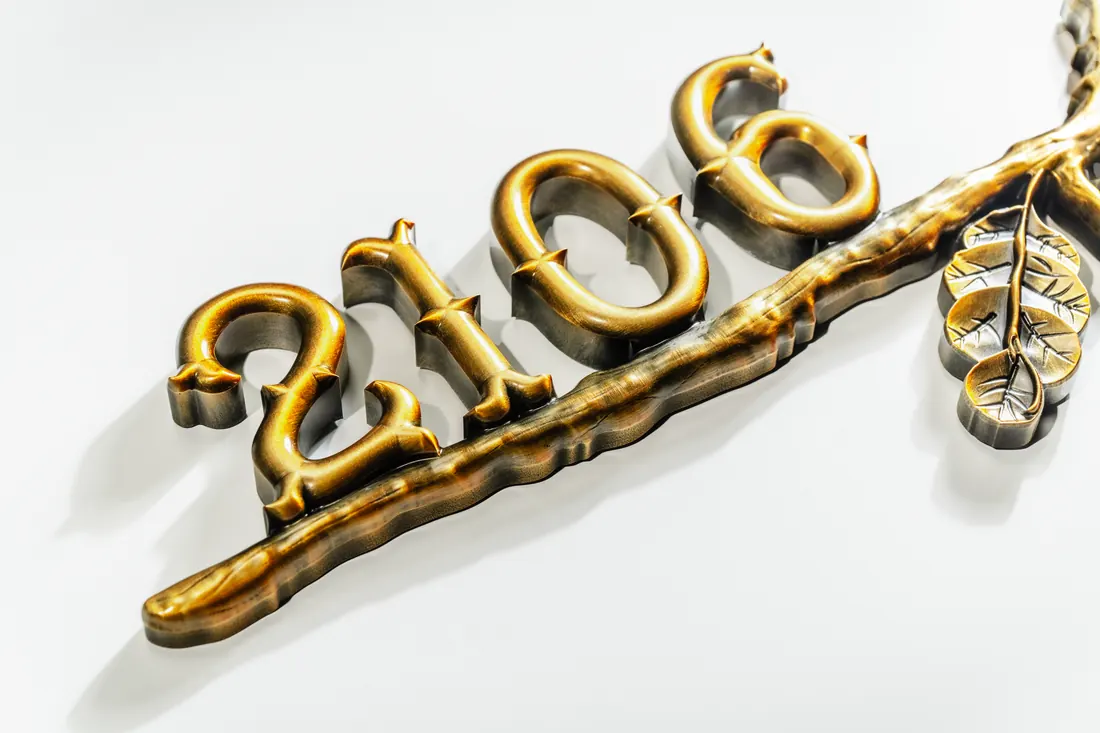 Outdoor branch-style address number detail in raised metallic finish