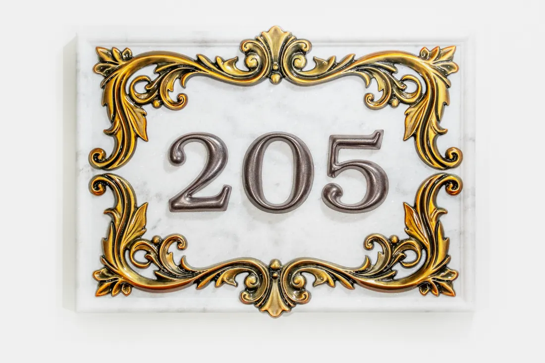Ornate custom address plaque 205 with raised metallic border and numerals