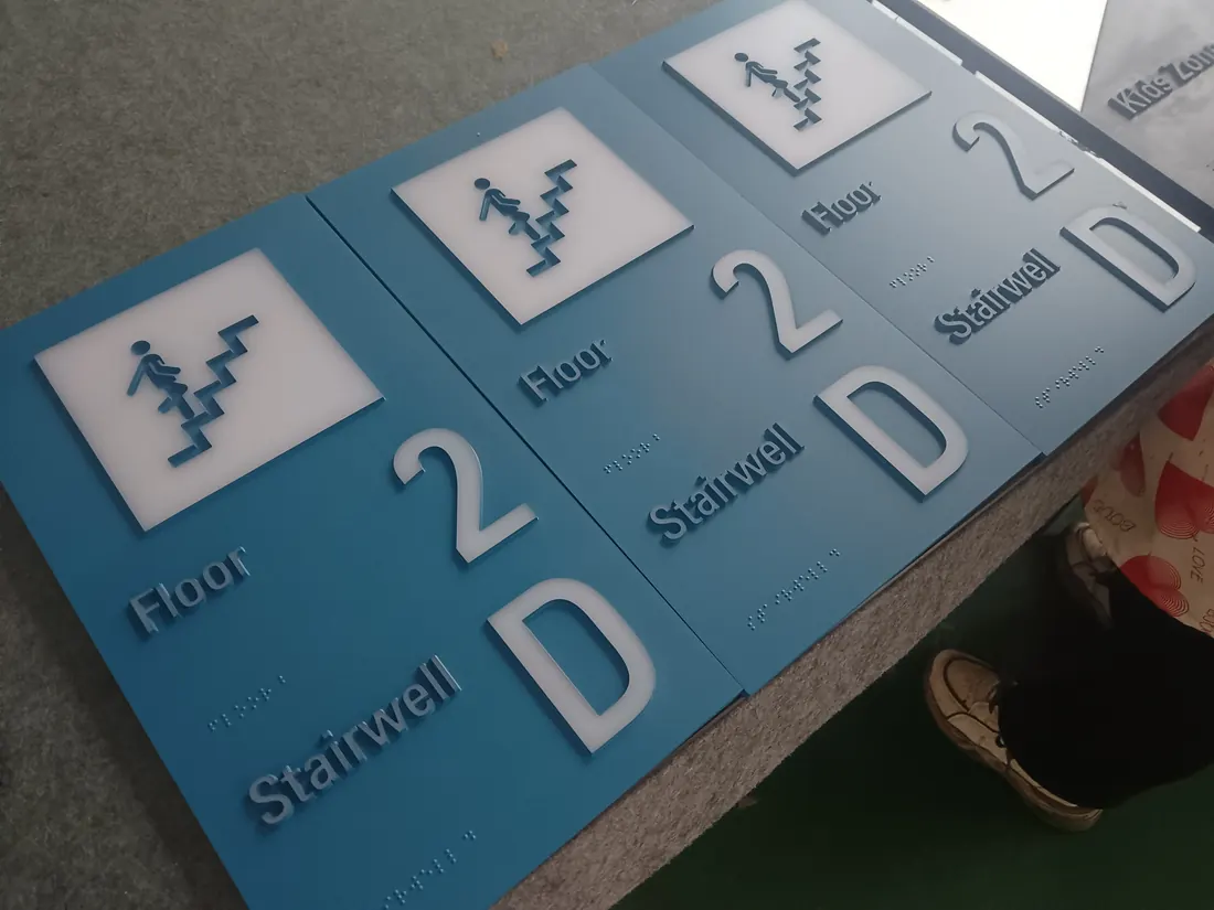 Bike storage room tactile sign with raised letters and braille dots