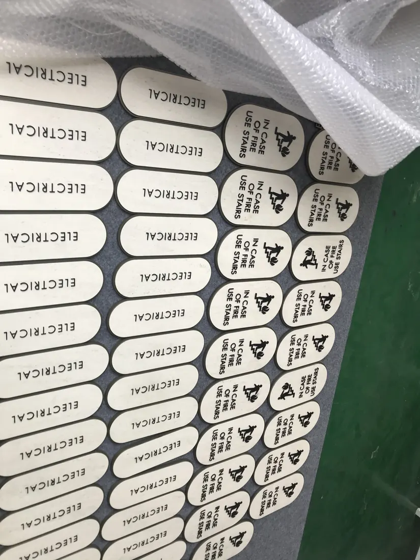 Stair level tactile sign set with raised letters and braille-style details