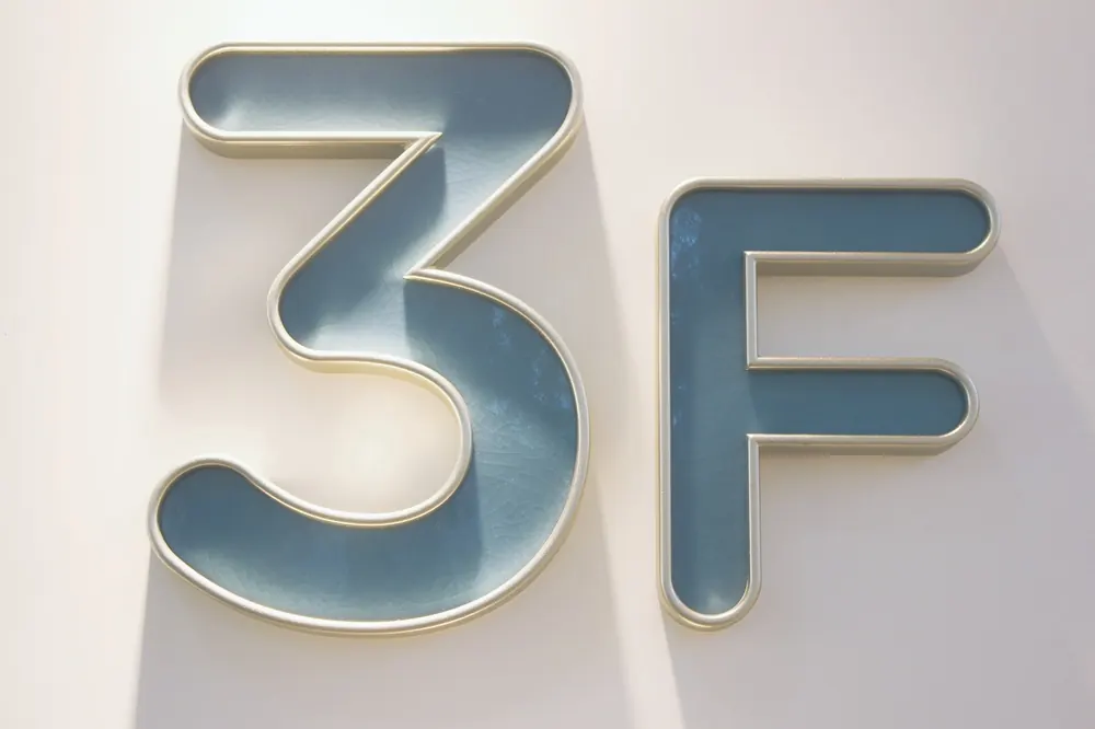 Hotel room number plaque with carved aluminum border and ceramic inner panel
