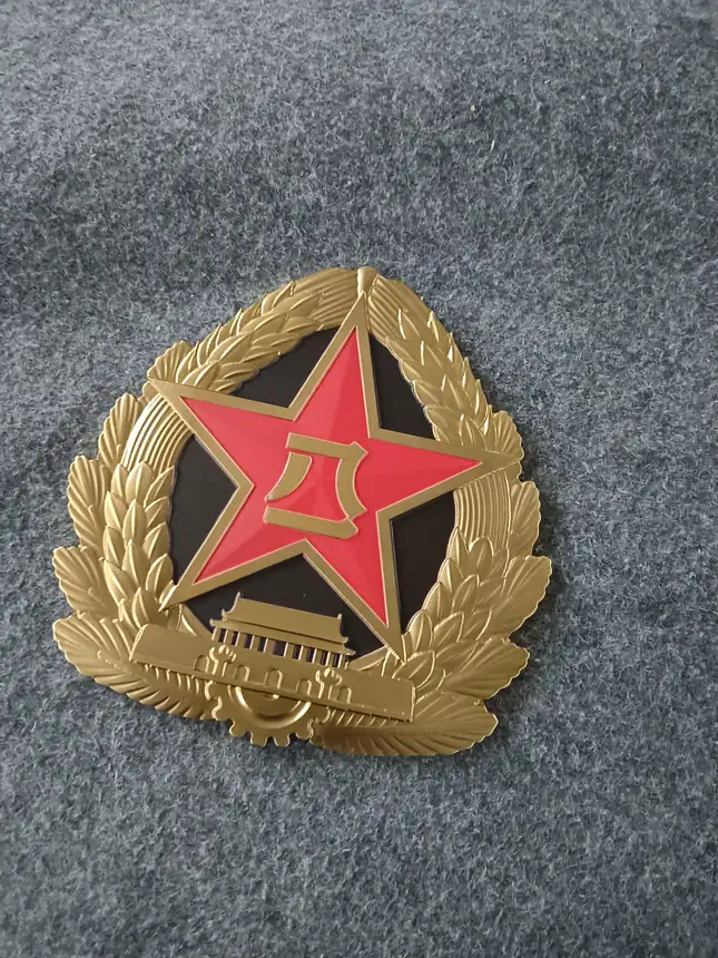 Oxidized decorative relief plaque sample with metallic badge detail