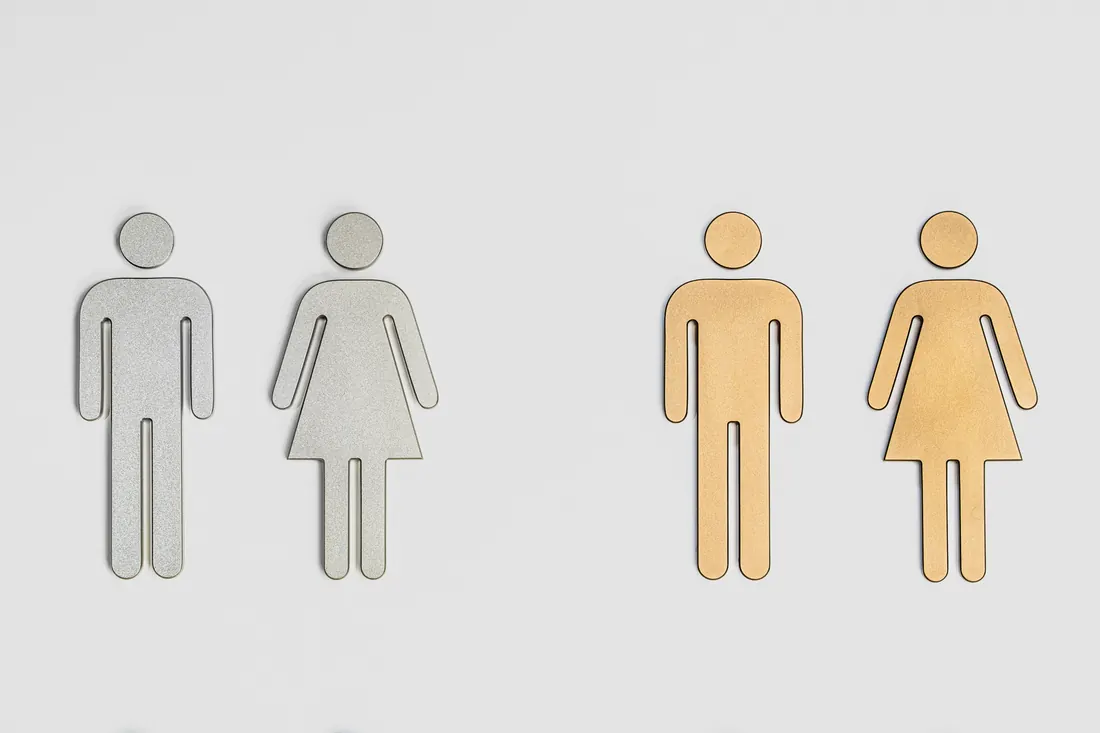 Minimal restroom icon pair in gray and gold finishes