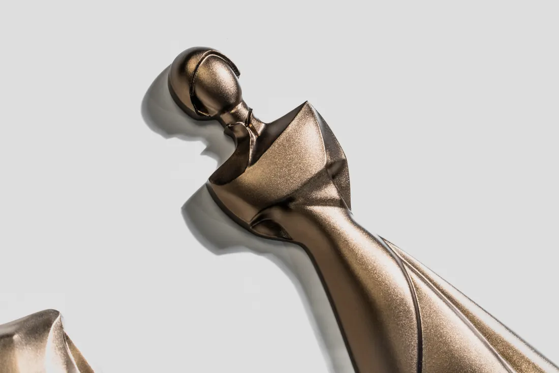 Sculptural restroom icon close-up with metallic finish