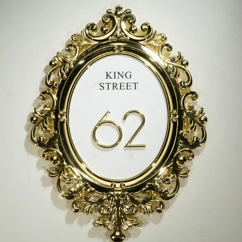 Ornate oval address plaque with raised number