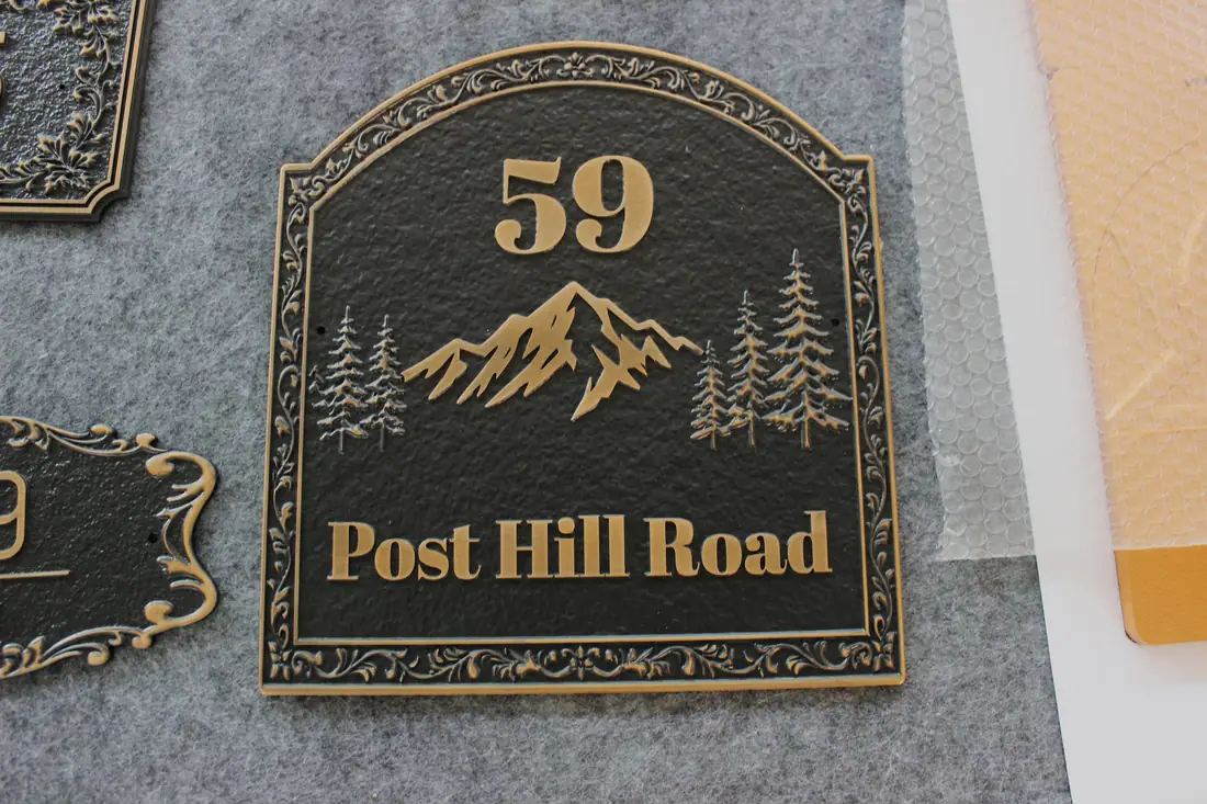 Arched exterior road plaque with raised letters