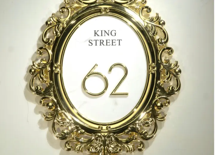 Exterior address plaque with raised numbers and decorative border